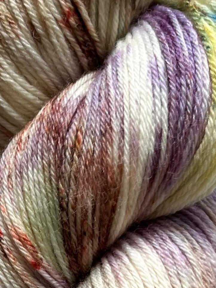Håndfarvet garn i Merino Bamboo uld. Dette håndfarvede strømpegarn er farvet med smukke nuancer af lilla, grøn og brun