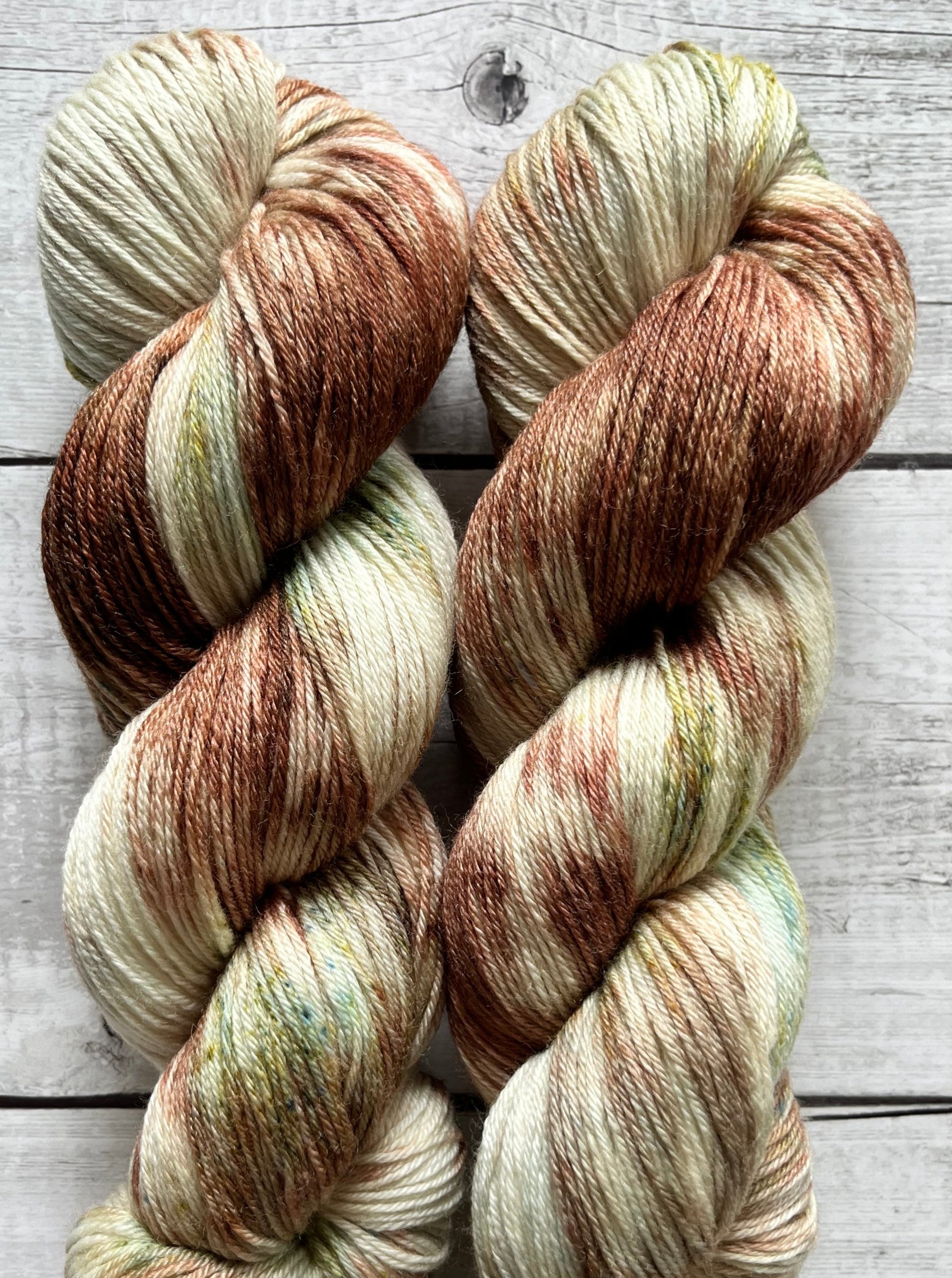 Håndfarvet garn i Merino Bamboo uld. Dette håndfarvede strømpegarn er farvet med smukke nuancer af brun og grøn