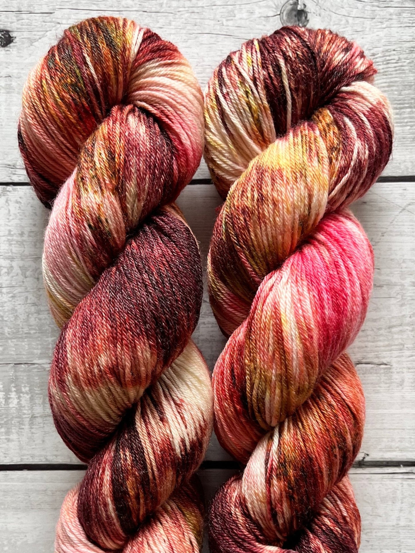 Håndfarvet garn i Merino Bamboo uld. Dette håndfarvede strømpegarn er farvet med smukke nuancer af bordeaux, pink og gylden brun